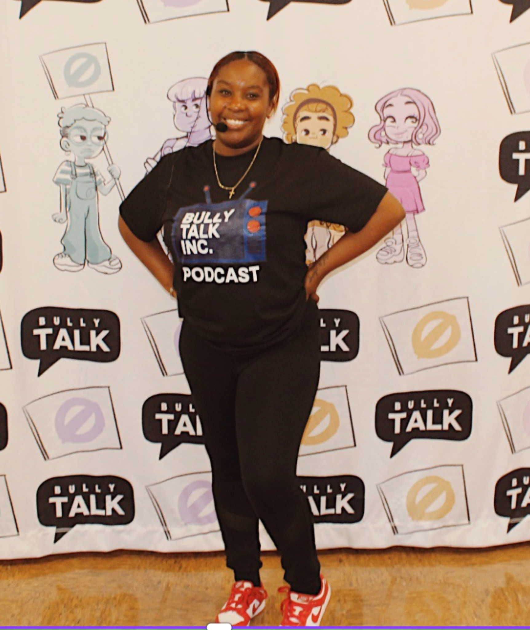 Bully Talk Inc. podcast host at a branded event backdrop