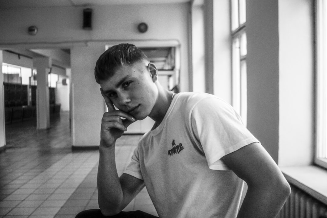 A young boy looking contemplative in a hallway