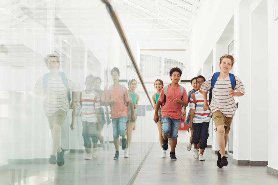 Diverse happy students walking down a bright school hallway